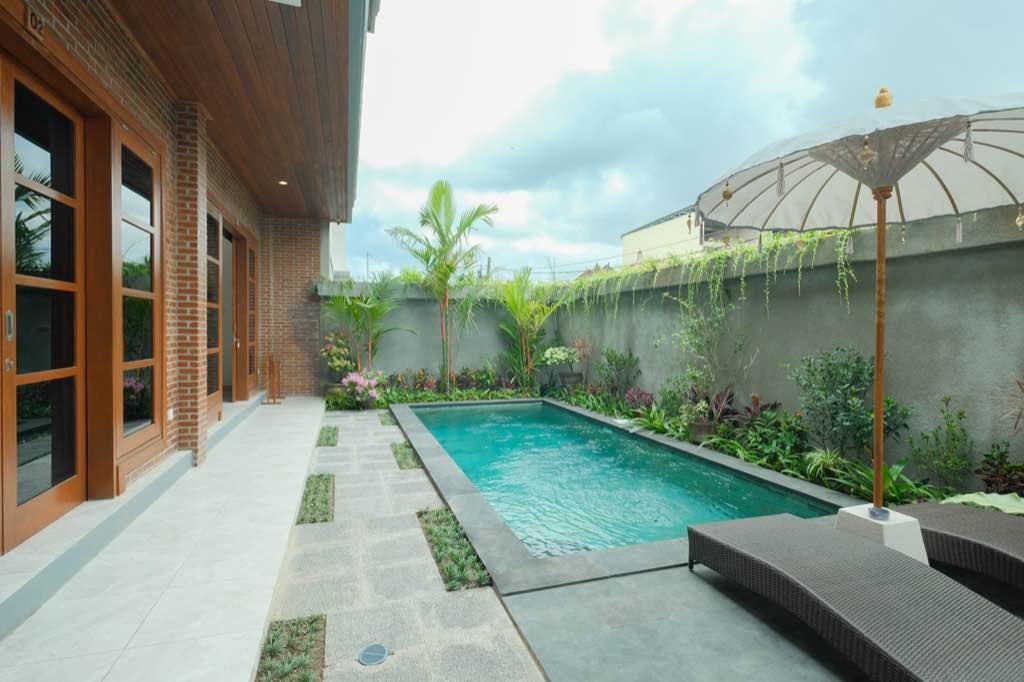 Santera Village — brick facade, garden pool and Balinese parasol