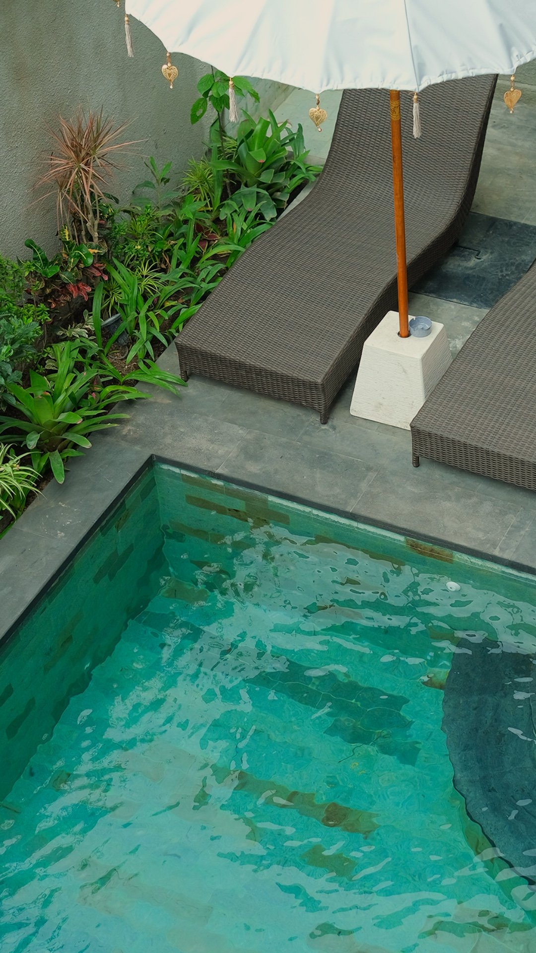 Pool corner with Balinese parasol and loungers